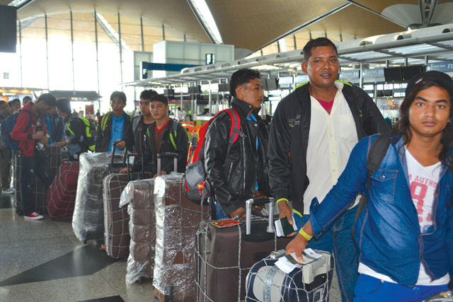 LEAVING IN DROVES: Nepali migrant workers queuing up for flights to Kathmandu at Kuala Lumpur International Airport last week.